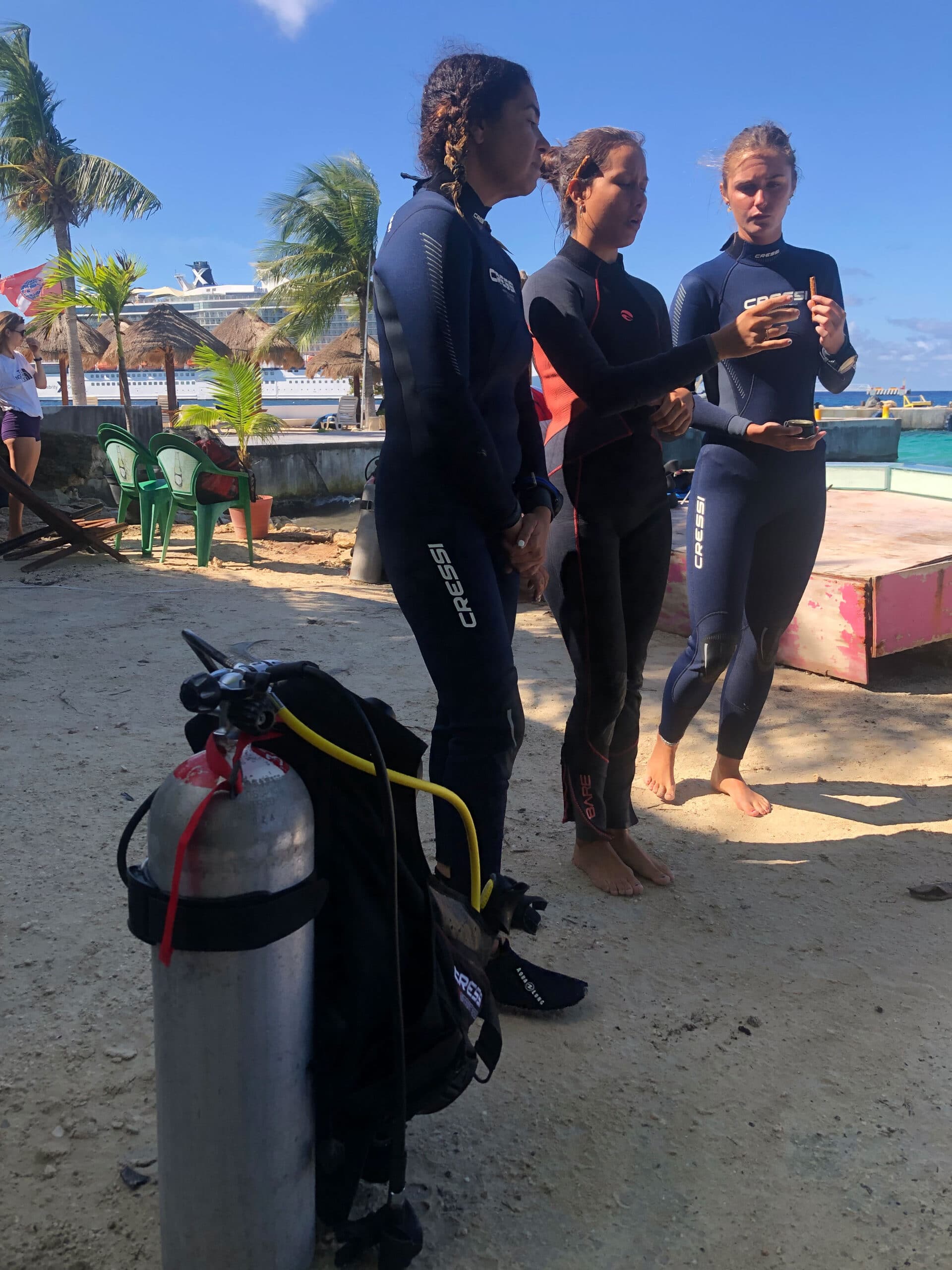 A Blue Mystic instructor reviews diving techniques and skills on the shore before entering the water for the lessons of the day.