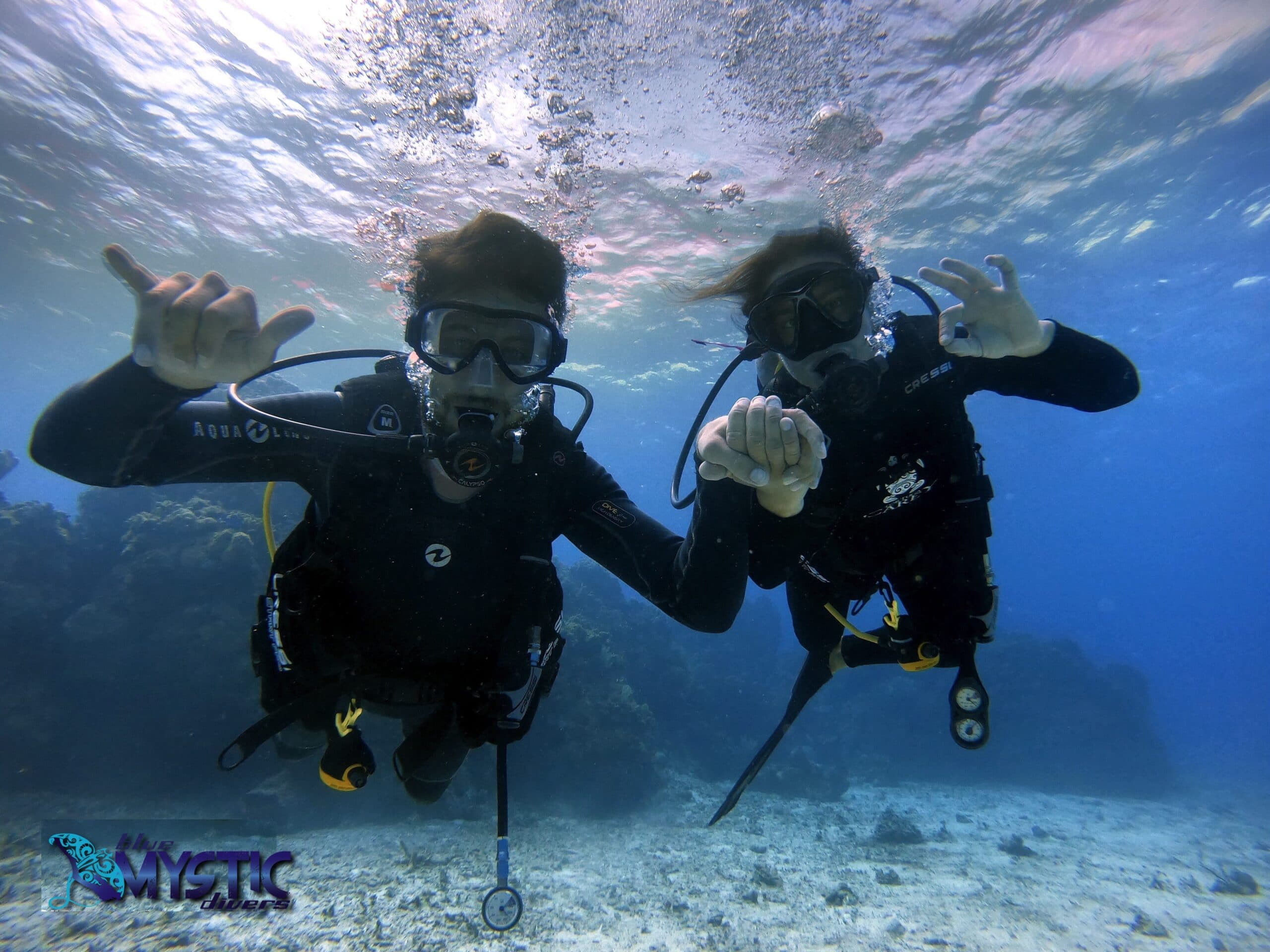 Happy couple underwater enjoying an Intro Dive session.