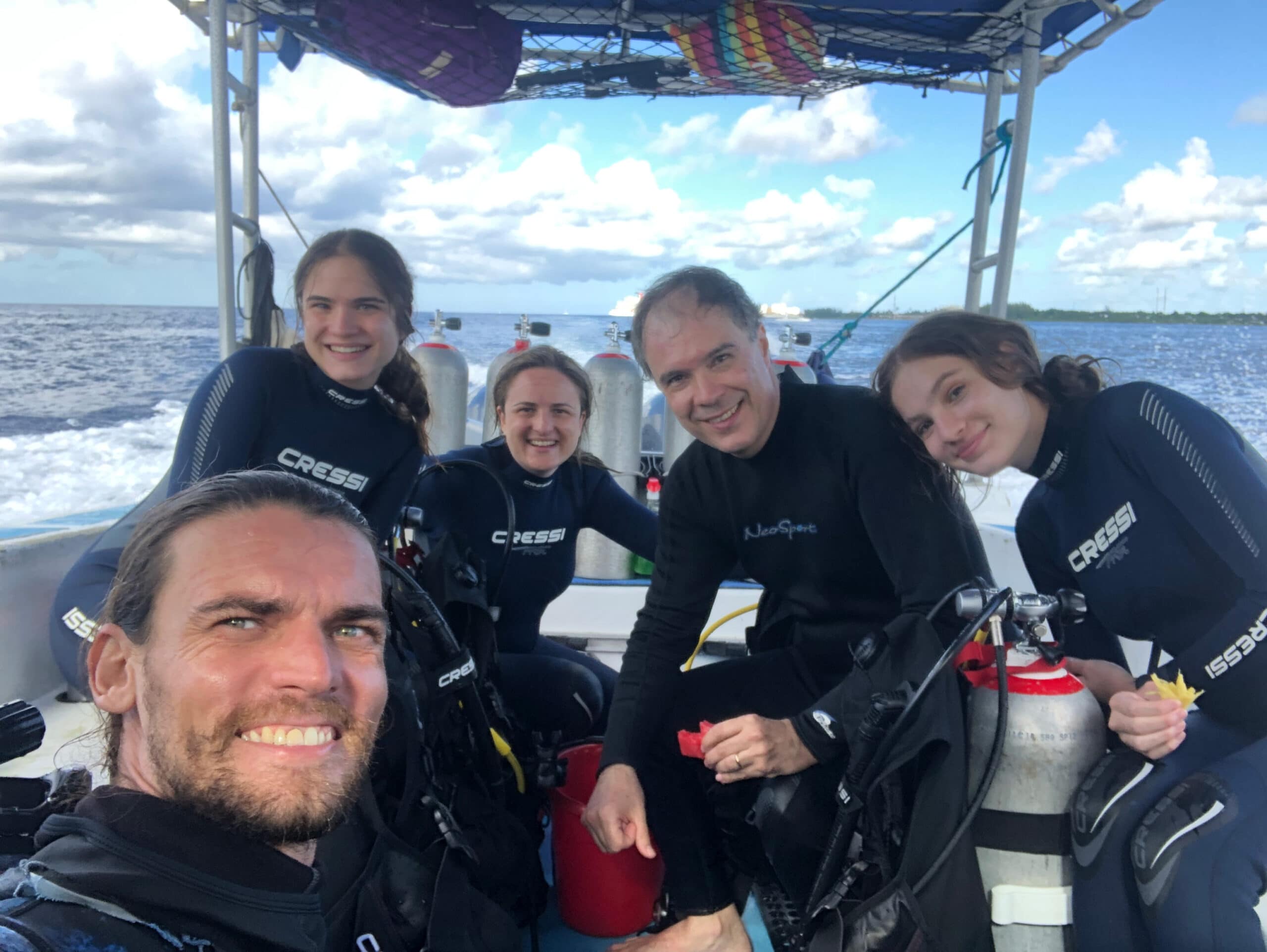 Owner Nico Simon and a Happy Family of Divers on a Boat