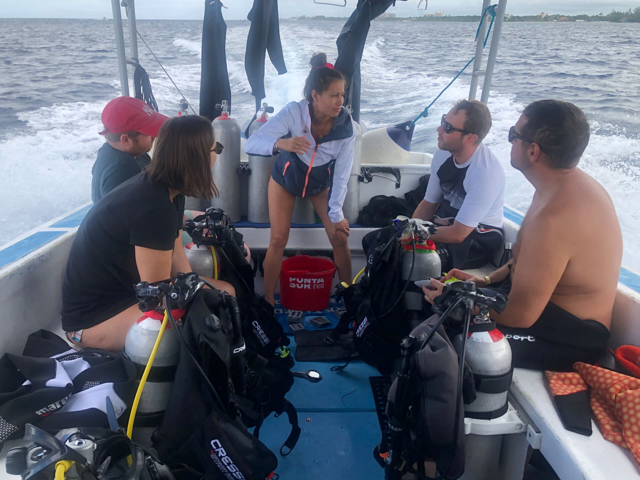 A Blue Mystic instructor briefs a class of Scuba Dive Review students on the boat before their dive.