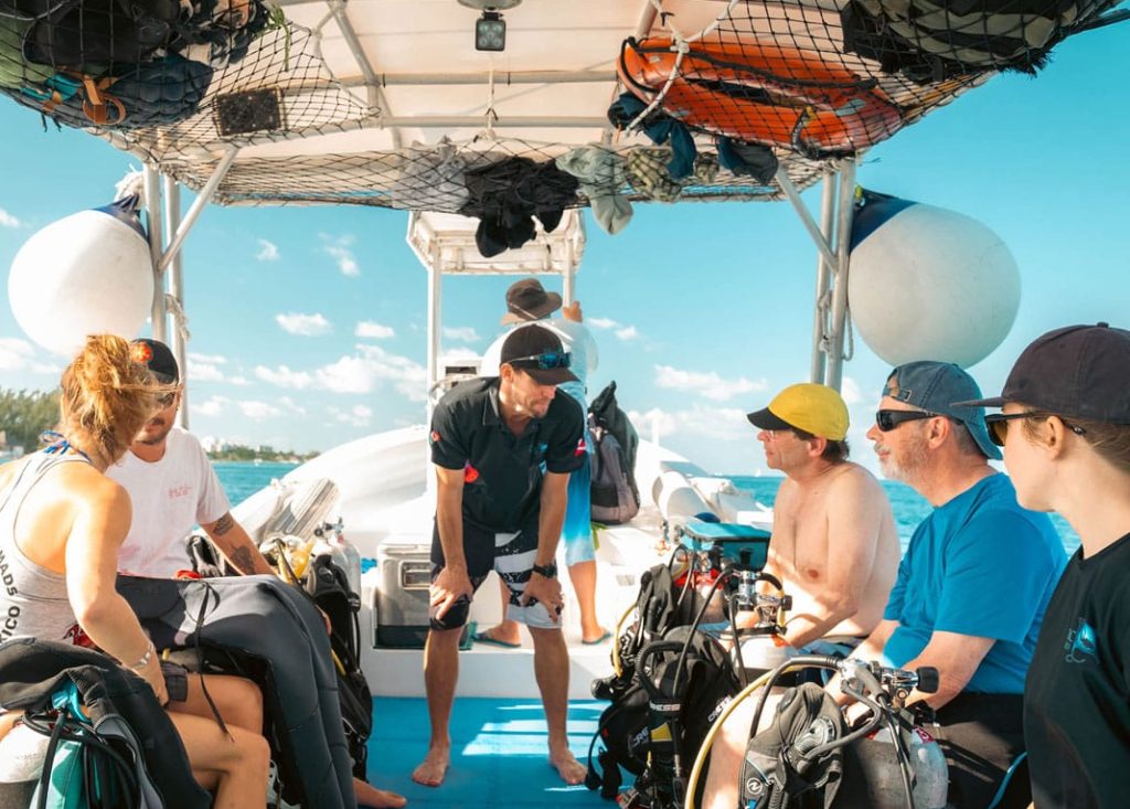 Owner Nico Simon and a Happy Family of Divers on a Boat