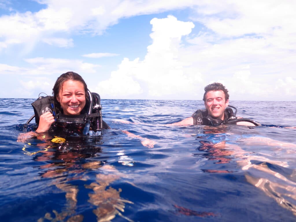 Happy couple enjoying a private dive at the surface of the sea.